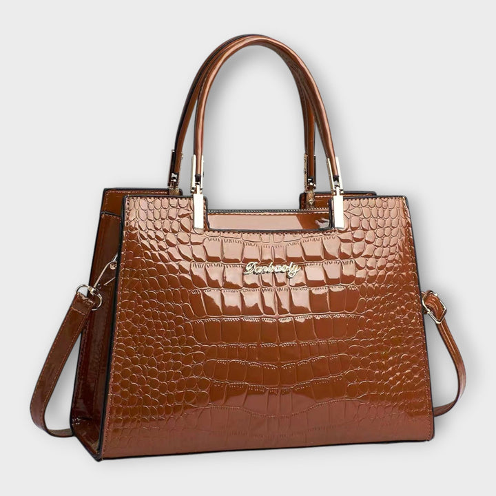 Cécile. - Bolsa de mão em padrão de pele de crocodilo brilhante