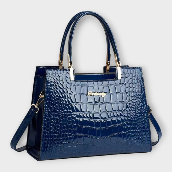 Cécile. - Bolsa de mão em padrão de pele de crocodilo brilhante