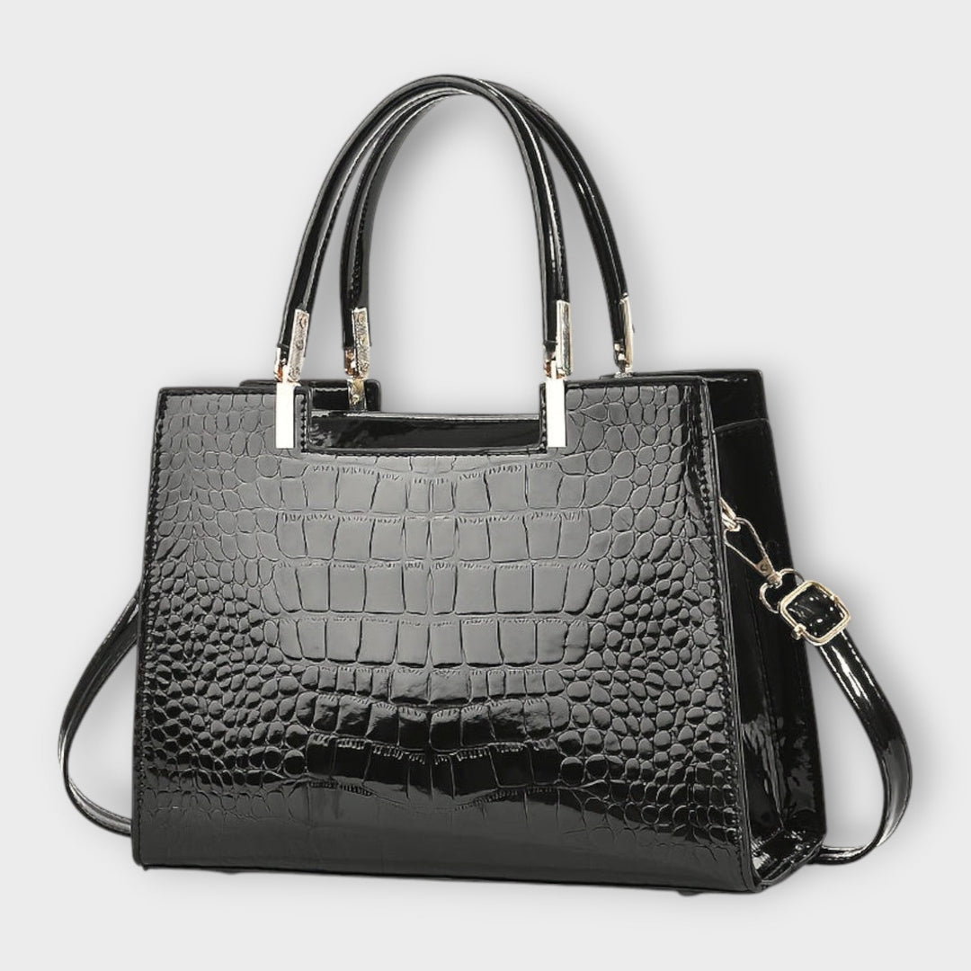 Cécile. - Bolsa de mão em padrão de pele de crocodilo brilhante