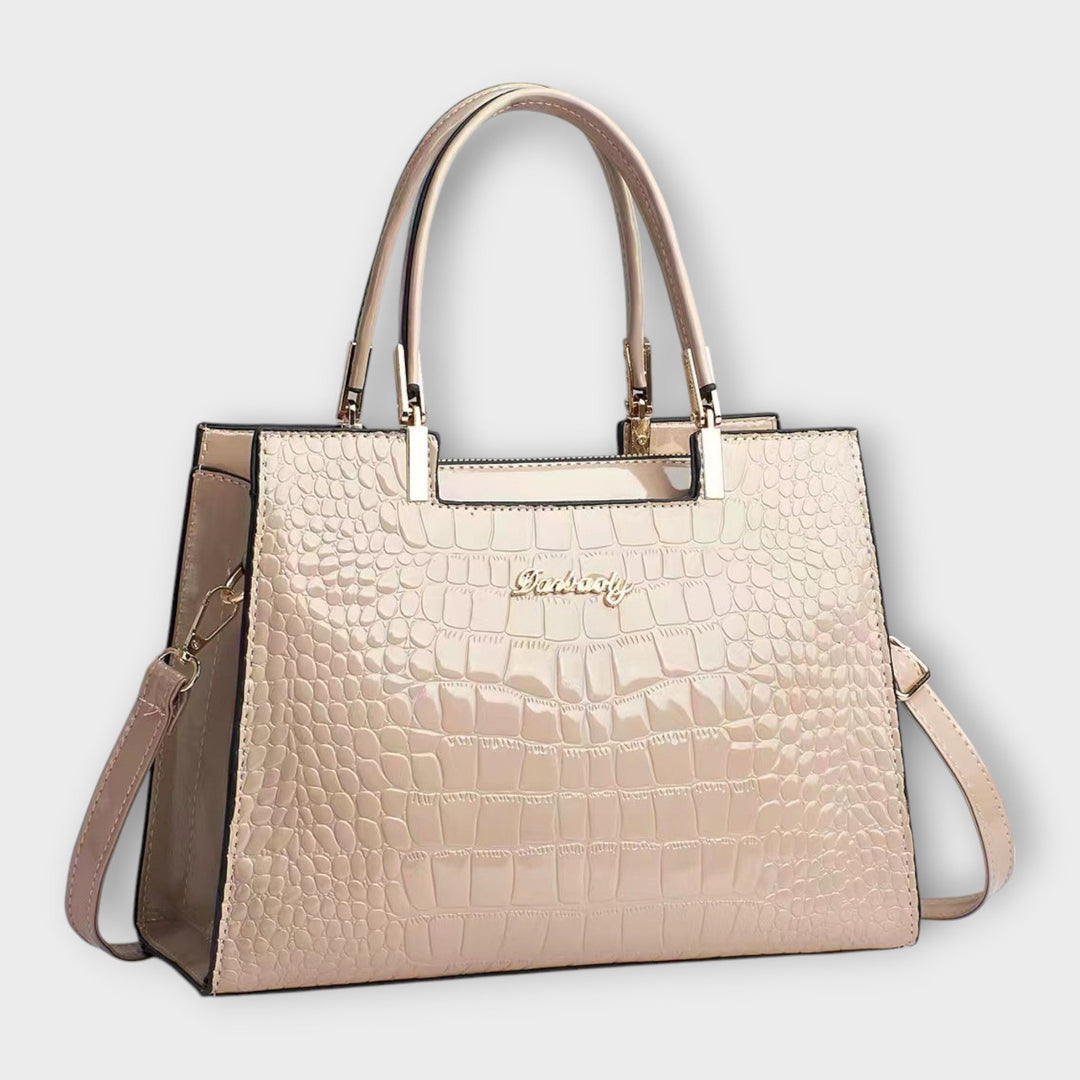 Cécile. - Bolsa de mão em padrão de pele de crocodilo brilhante