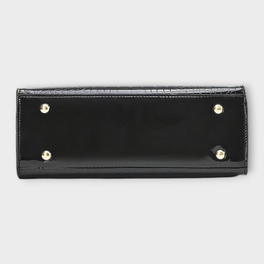 Cécile. - Bolsa de mão em padrão de pele de crocodilo brilhante