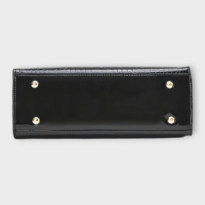 Cécile. - Bolsa de mão em padrão de pele de crocodilo brilhante